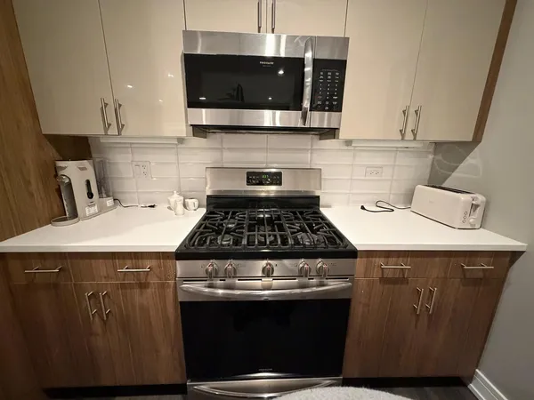 a kitchen with a stove and a microwave