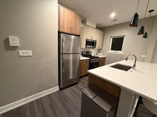 a kitchen with a refrigerator and a sink