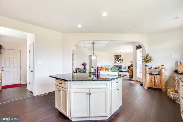 a kitchen with a sink cabinets and wooden floor