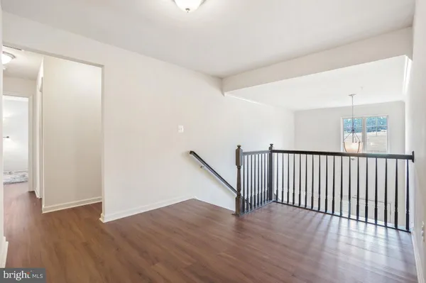a bedroom with furniture and a wooden floor