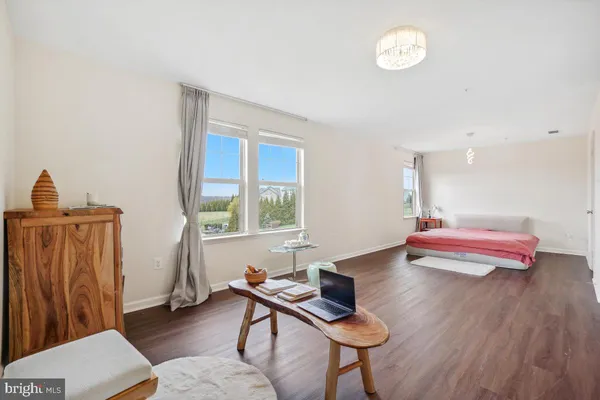 a bedroom with furniture and a wooden floor