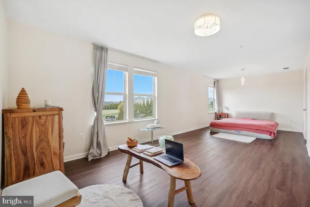 a bedroom with furniture and a wooden floor