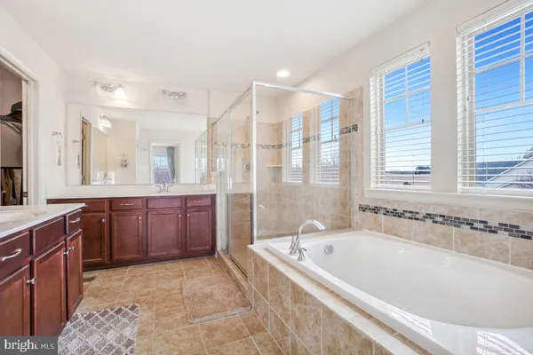 a spacious bathroom with a granite countertop sink mirror and double
