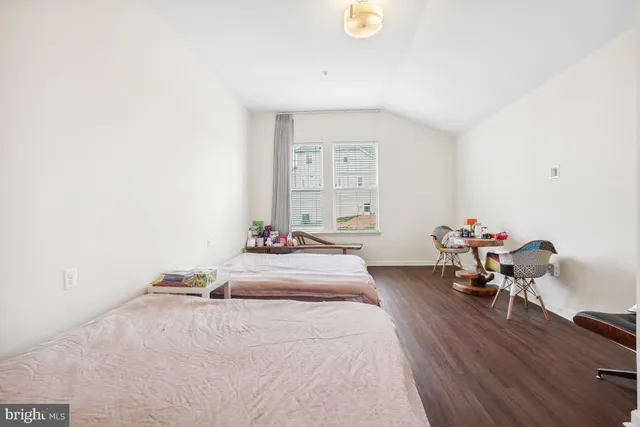 a bedroom with two beds and a night stand