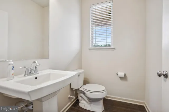 a bathroom with a sink mirror and toilet