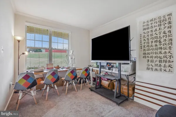 a view of a room with furniture air hockey table and chairs