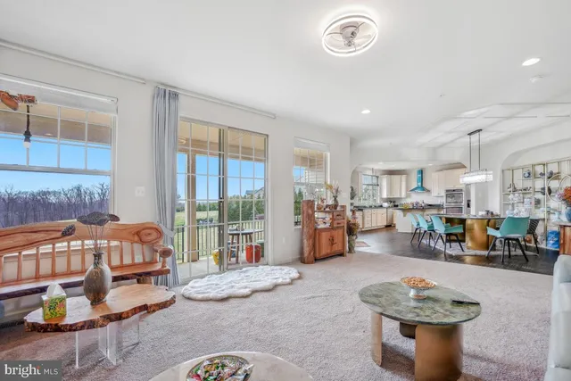 a living room with furniture and a floor to ceiling window