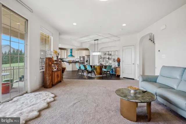 a view of a livingroom with kitchen and dining room