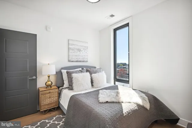 a bedroom with a bed and a window