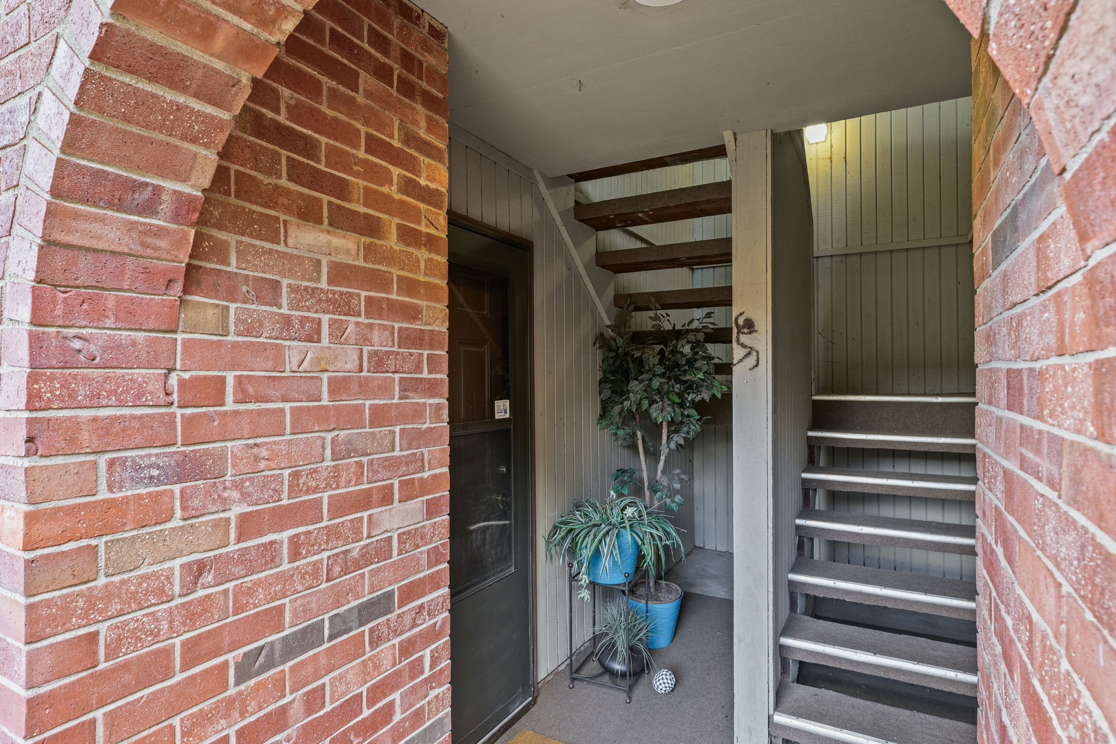 1304 Christopher Circle, Unit 1 Urbana, IL 61802 - Photo 2 of 18 a view of a door with wooden floor and a potted plant