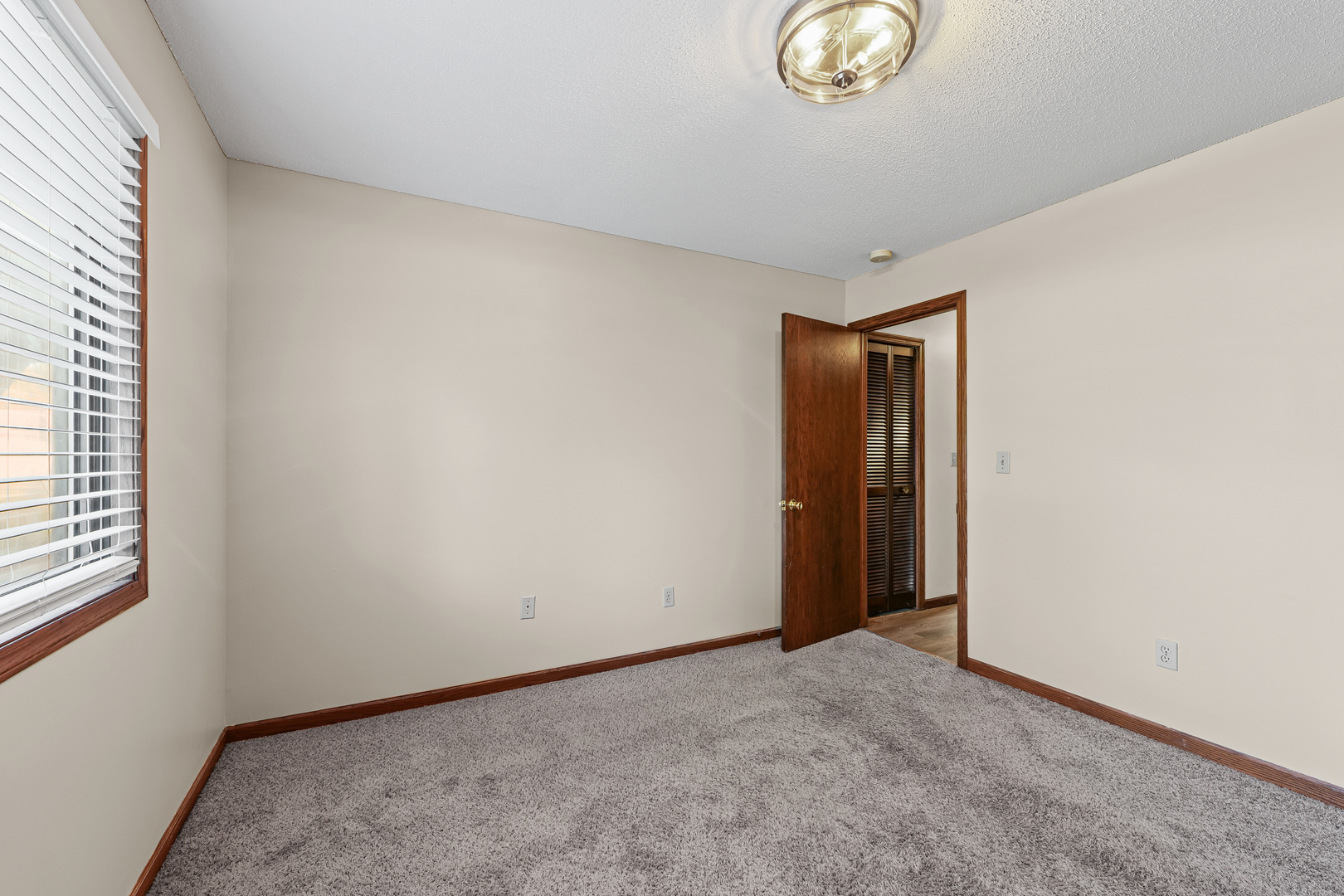 1304 Christopher Circle, Unit 1 Urbana, IL 61802 - Photo 10 of 18 a view of an empty room with a window