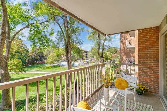 a view of a porch with chairs and backyard