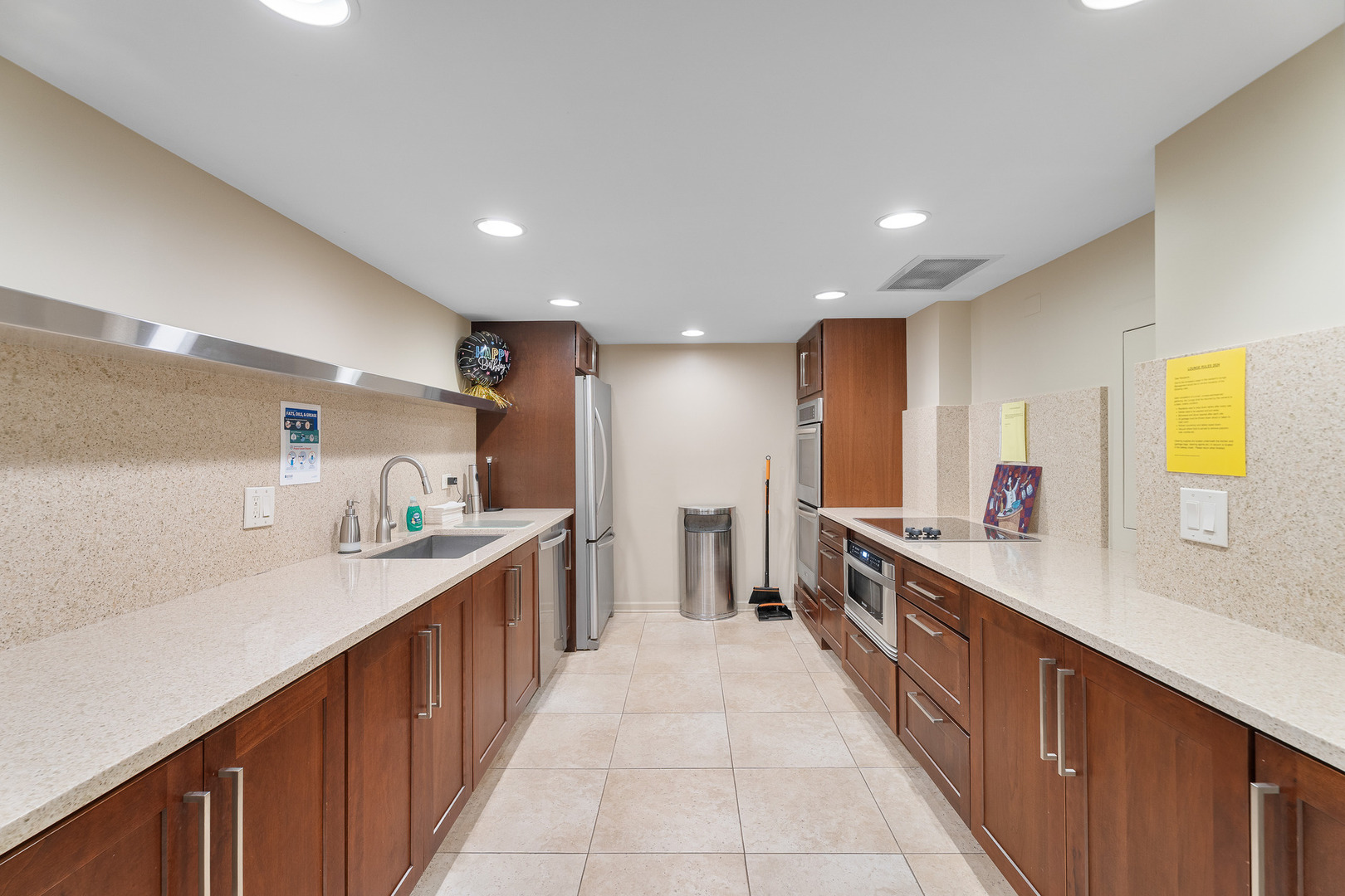 22 Park Lane, Unit 203 Park Ridge, IL 60068 - Photo 22 of 33 a large kitchen with a large counter top a sink a window and stainless steel appliances