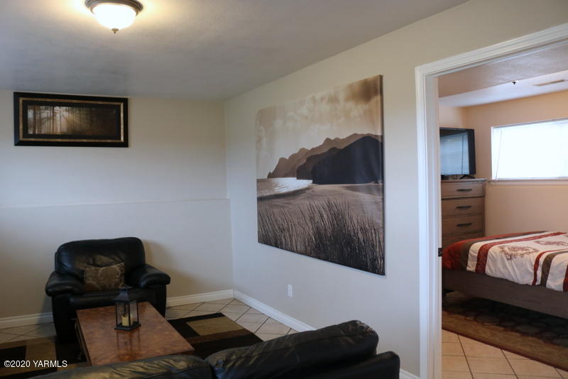 2491 Lateral 1 Road Wapato, WA 98951 - Photo 12 of 26 a bedroom with a bed and a chair