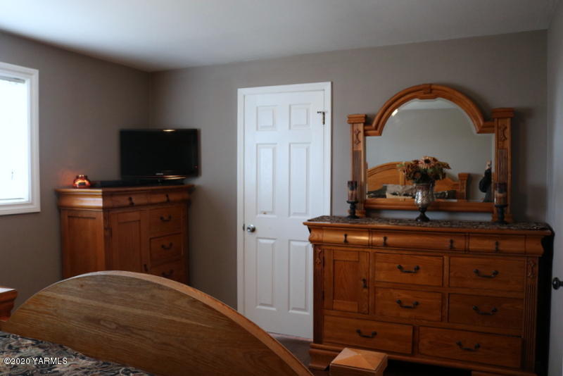 2491 Lateral 1 Road Wapato, WA 98951 - Photo 16 of 26 a bedroom with a bed and a television