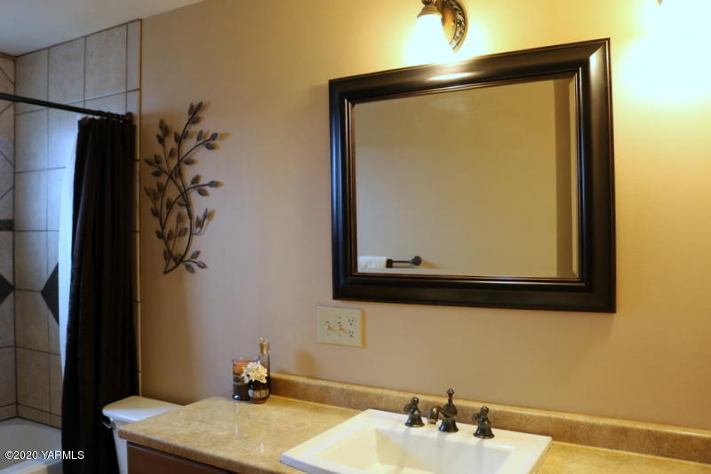 2491 Lateral 1 Road Wapato, WA 98951 - Photo 20 of 26 a bathroom with a sink a mirror and a shower
