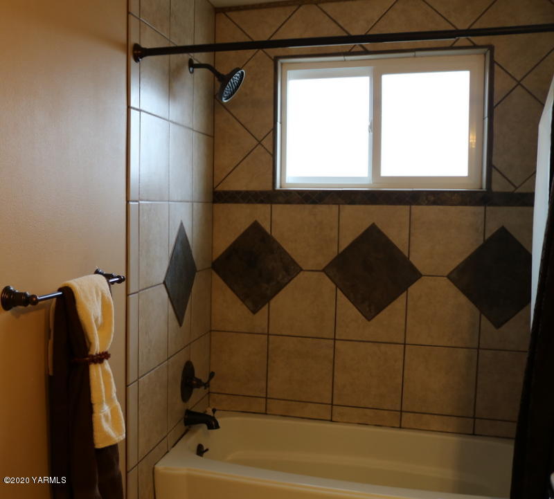 2491 Lateral 1 Road Wapato, WA 98951 - Photo 21 of 26 a bathroom with a bathtub and a shower