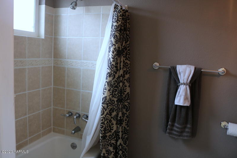 2491 Lateral 1 Road Wapato, WA 98951 - Photo 22 of 26 a bathroom with a shower curtain and a sink
