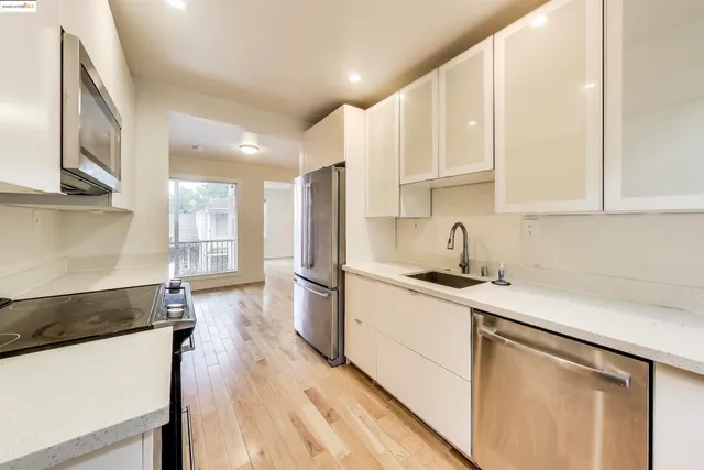a kitchen with a sink stove and refrigerator