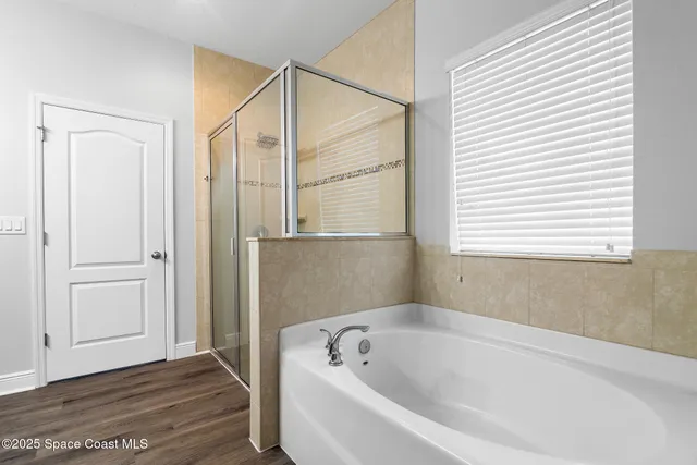 a bathroom with a bathtub and a window
