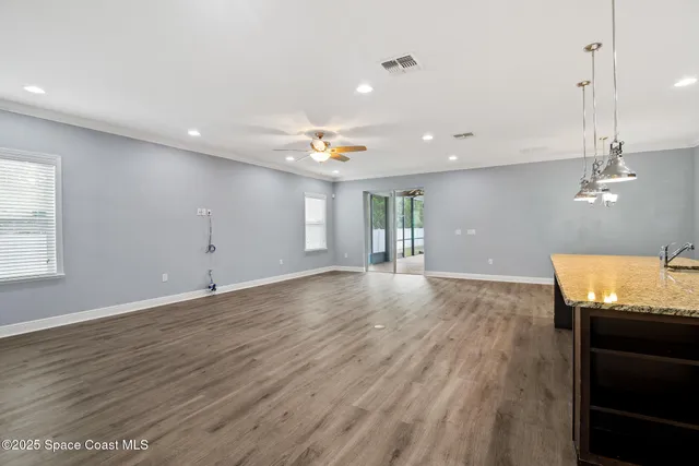 a view of a room with wooden floor