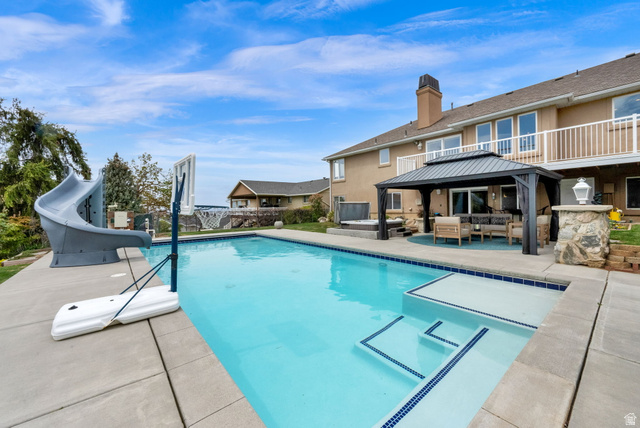 1506 Lakeview Drive Bountiful, UT 84010 - Photo 45 of 58 View of pool featuring patio surround, a water slide, outdoor lounge area, and a gazebo