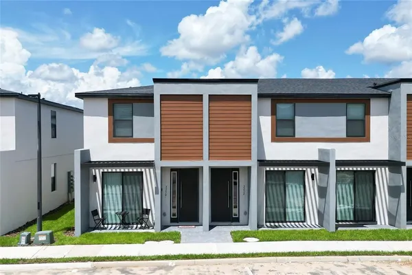 a view of a brick house with many windows