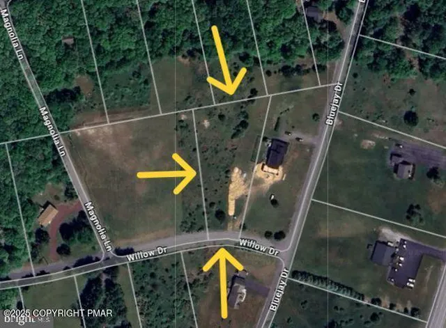 an aerial view of a house with a swimming pool