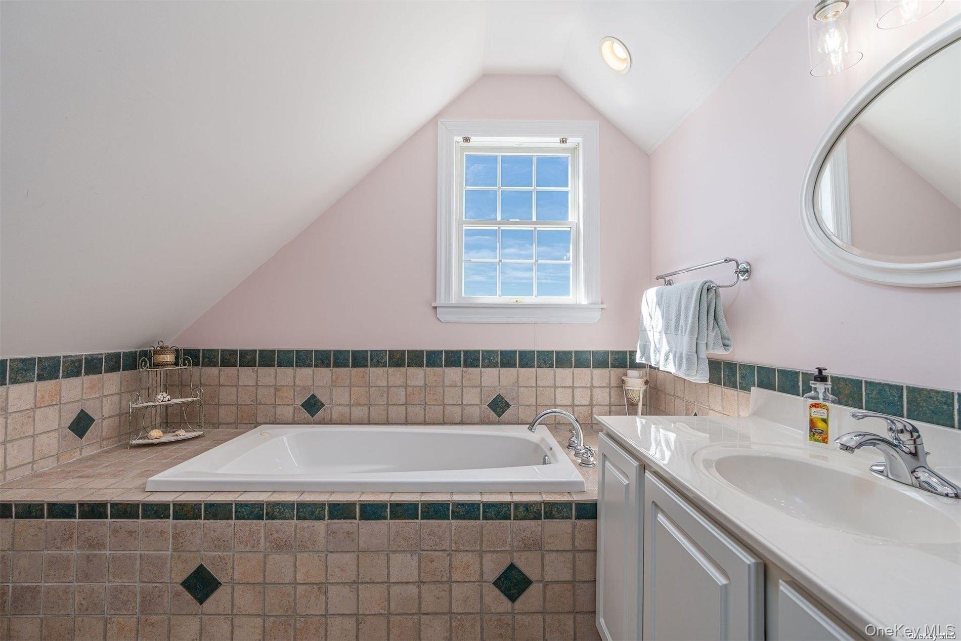 953 B Dune Road Westhampton Beach, NY 11978 - Photo 29 of 36 a bathroom with a sink a mirror and a bathtub
