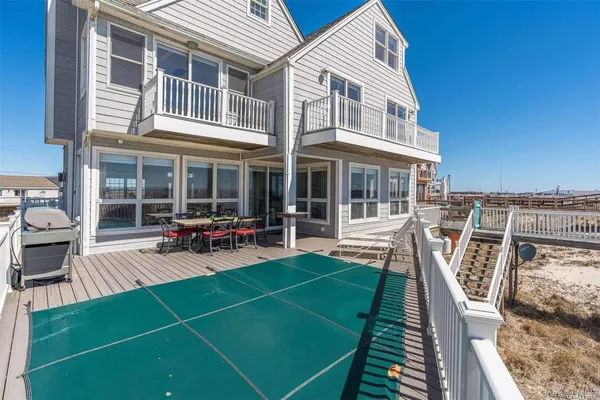a view of a house with backyard porch and sitting area
