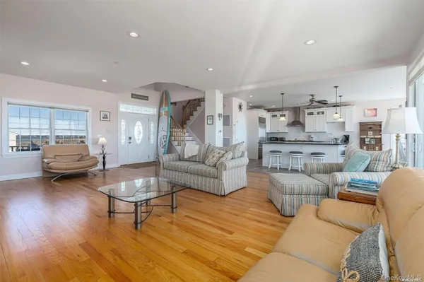 a living room with furniture and a dining table with kitchen view