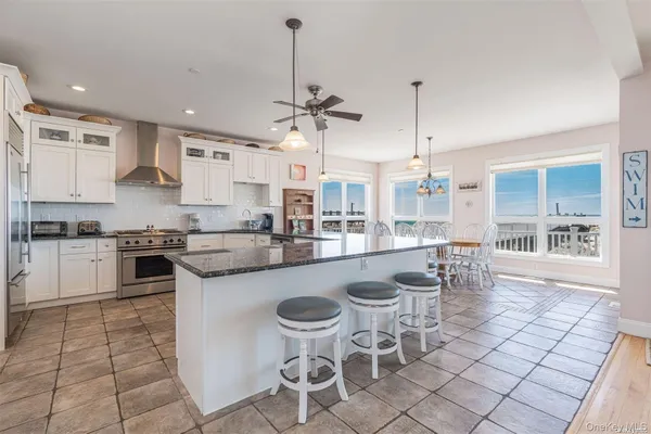 a large kitchen with a table and chairs