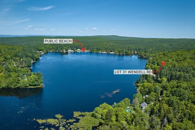 an aerial view of ocean with residential houses with outdoor space and seating