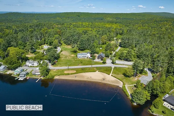 a view of a lake with houses in the background
