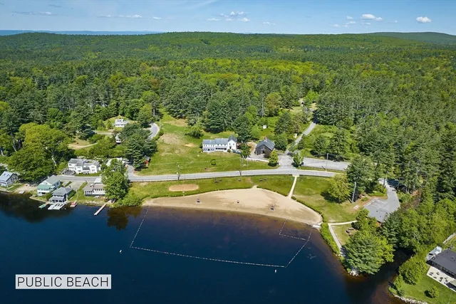 a view of a lake with houses in the background