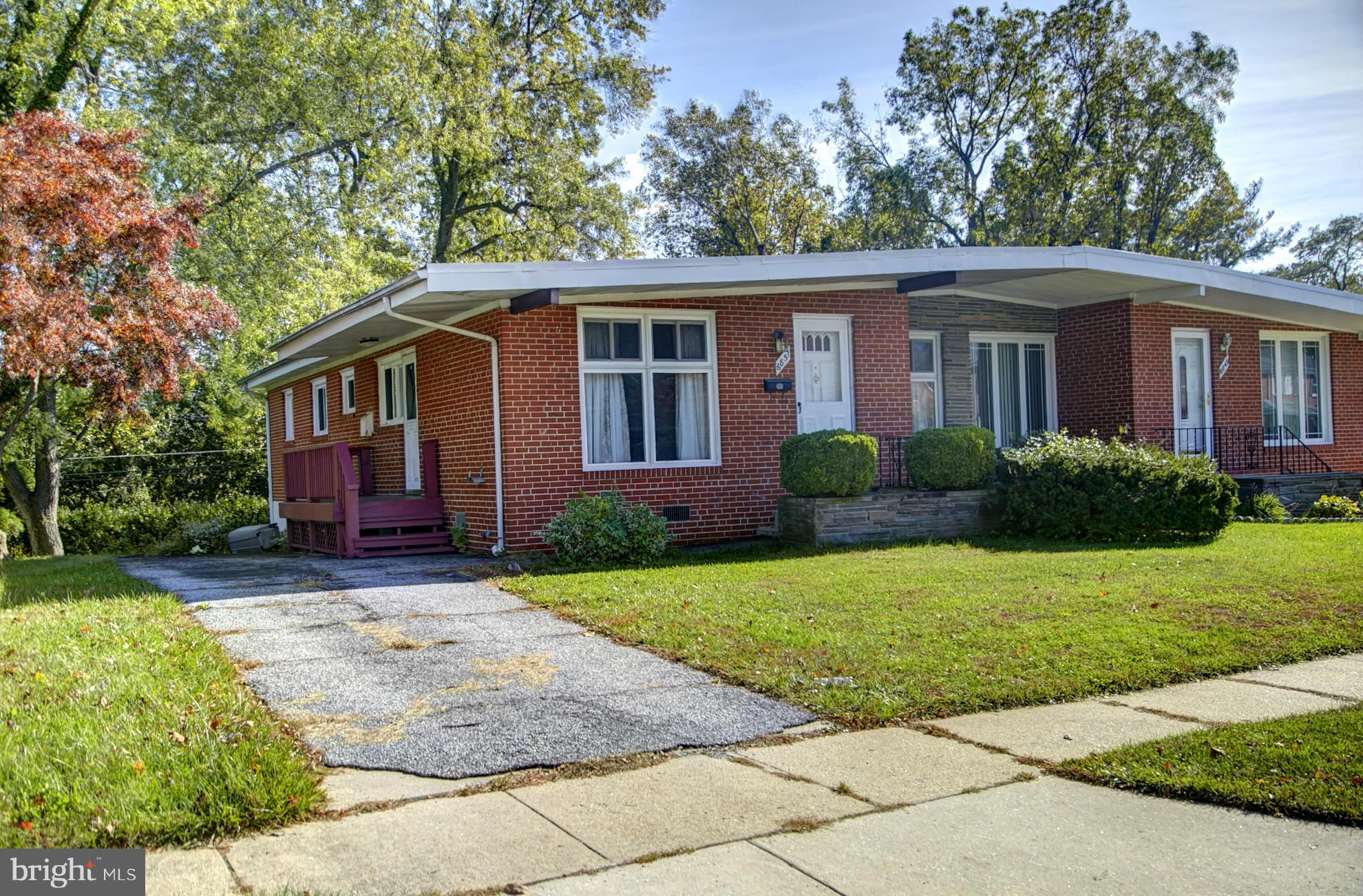 6851 Queens Ferry Road Baltimore, MD 21239 - Photo 1 of 25 a front view of a house with garden