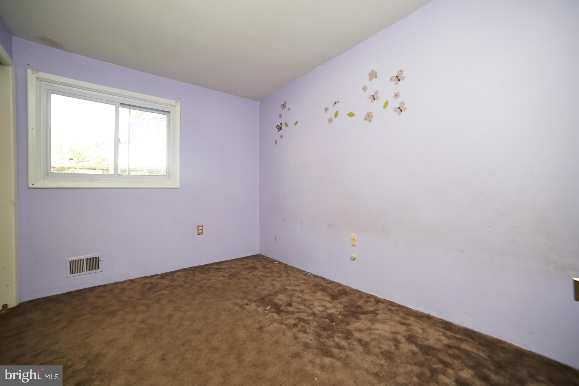6851 Queens Ferry Road Baltimore, MD 21239 - Photo 19 of 25 a view of a room with window and ceiling fan