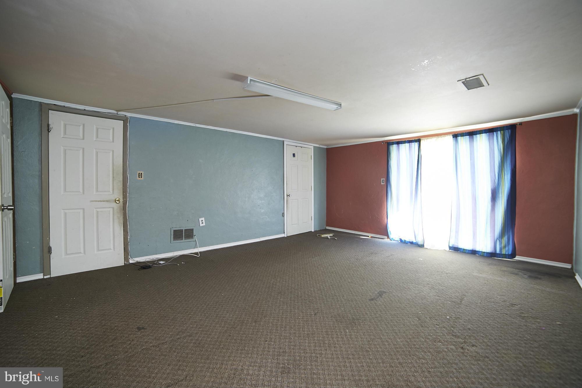 6851 Queens Ferry Road Baltimore, MD 21239 - Photo 21 of 25 a view of an empty room with a window