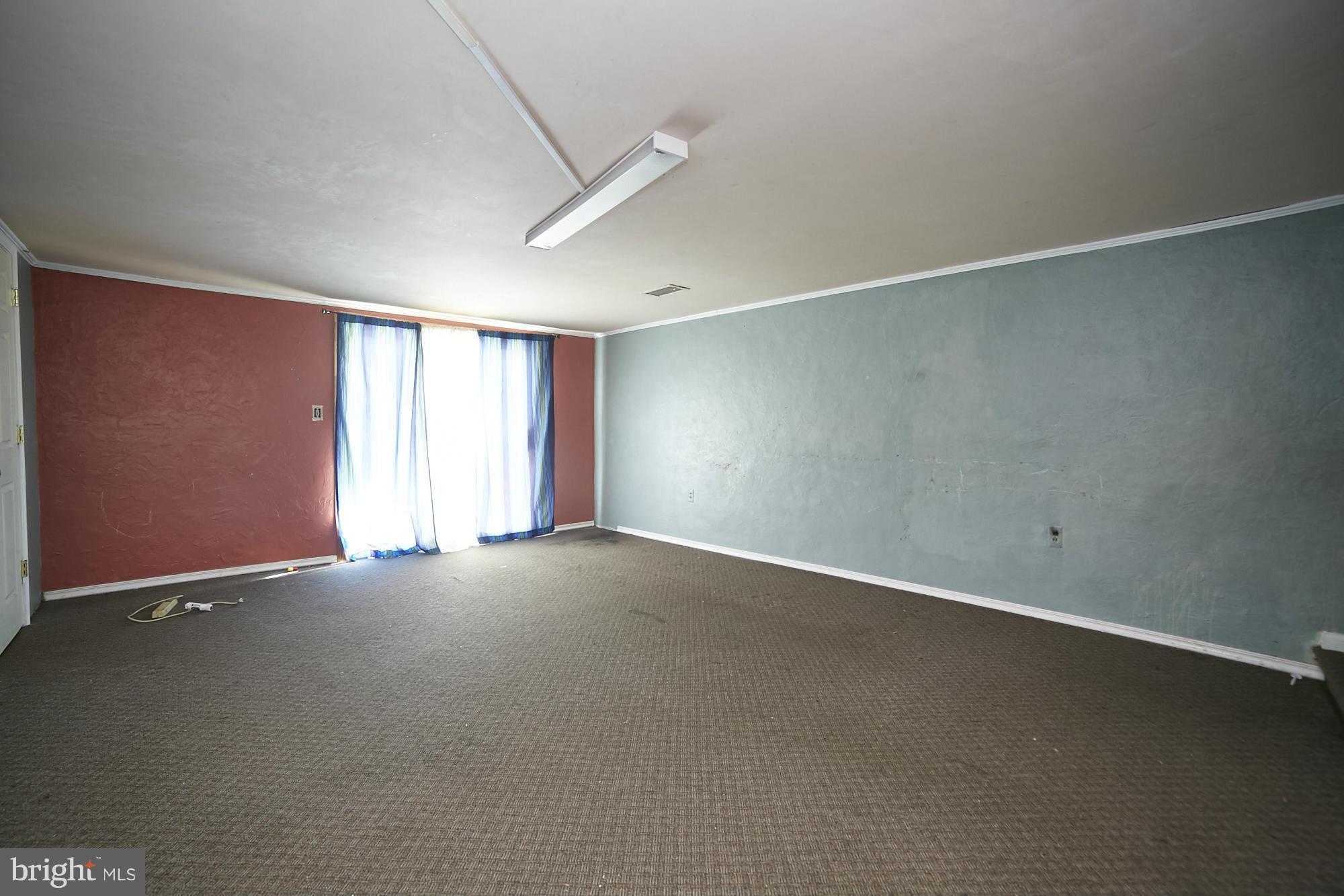 6851 Queens Ferry Road Baltimore, MD 21239 - Photo 23 of 25 an empty room with windows and closet