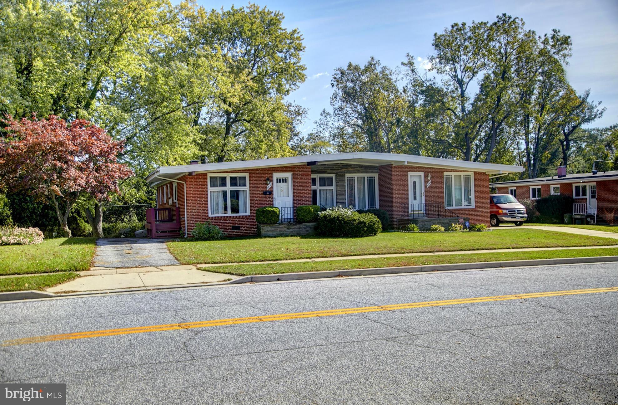 6851 Queens Ferry Road Baltimore, MD 21239 - Photo 3 of 25 a view of house with outdoor space and trees in the background