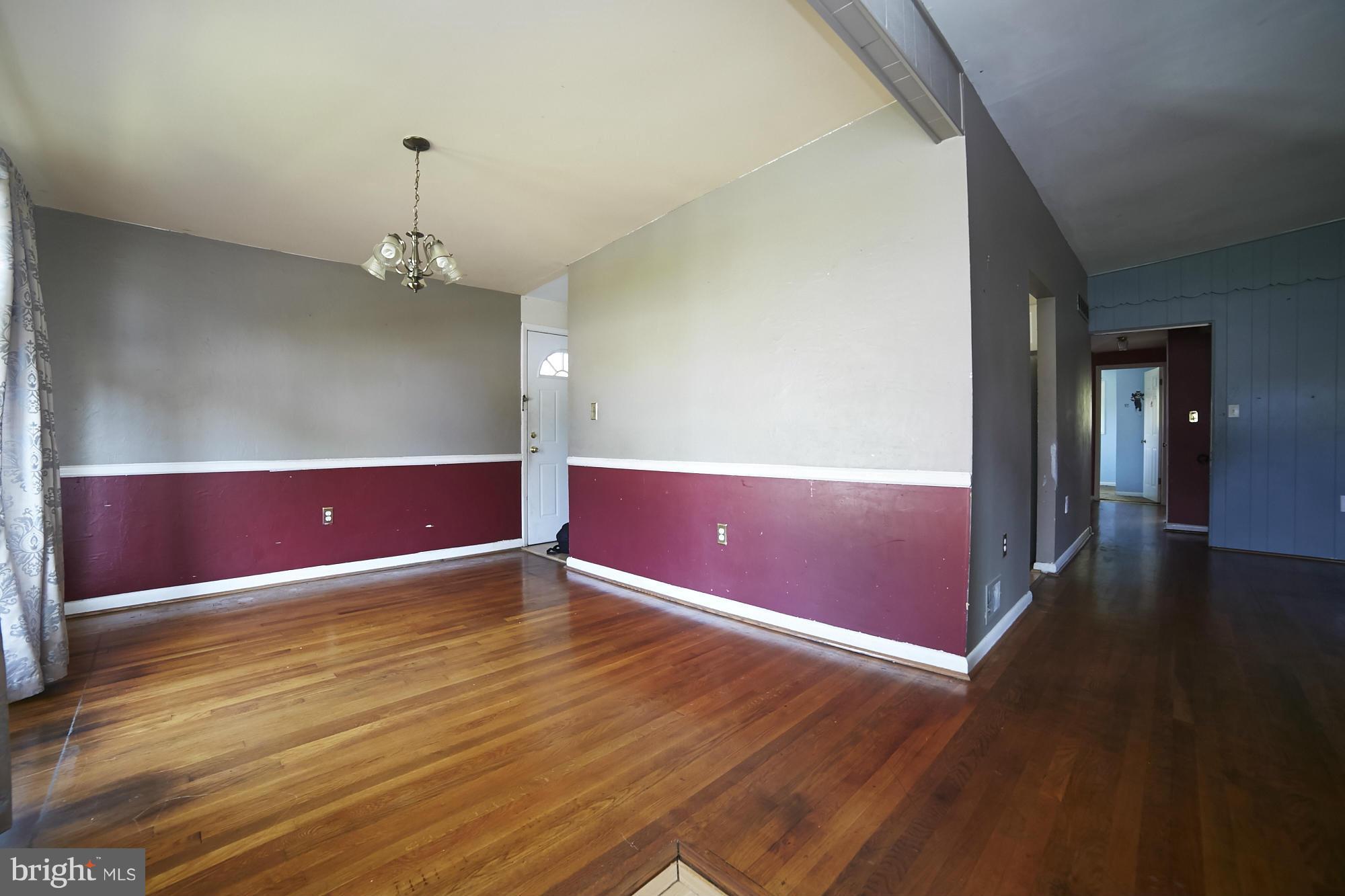 6851 Queens Ferry Road Baltimore, MD 21239 - Photo 5 of 25 a view of room with window and wooden floor