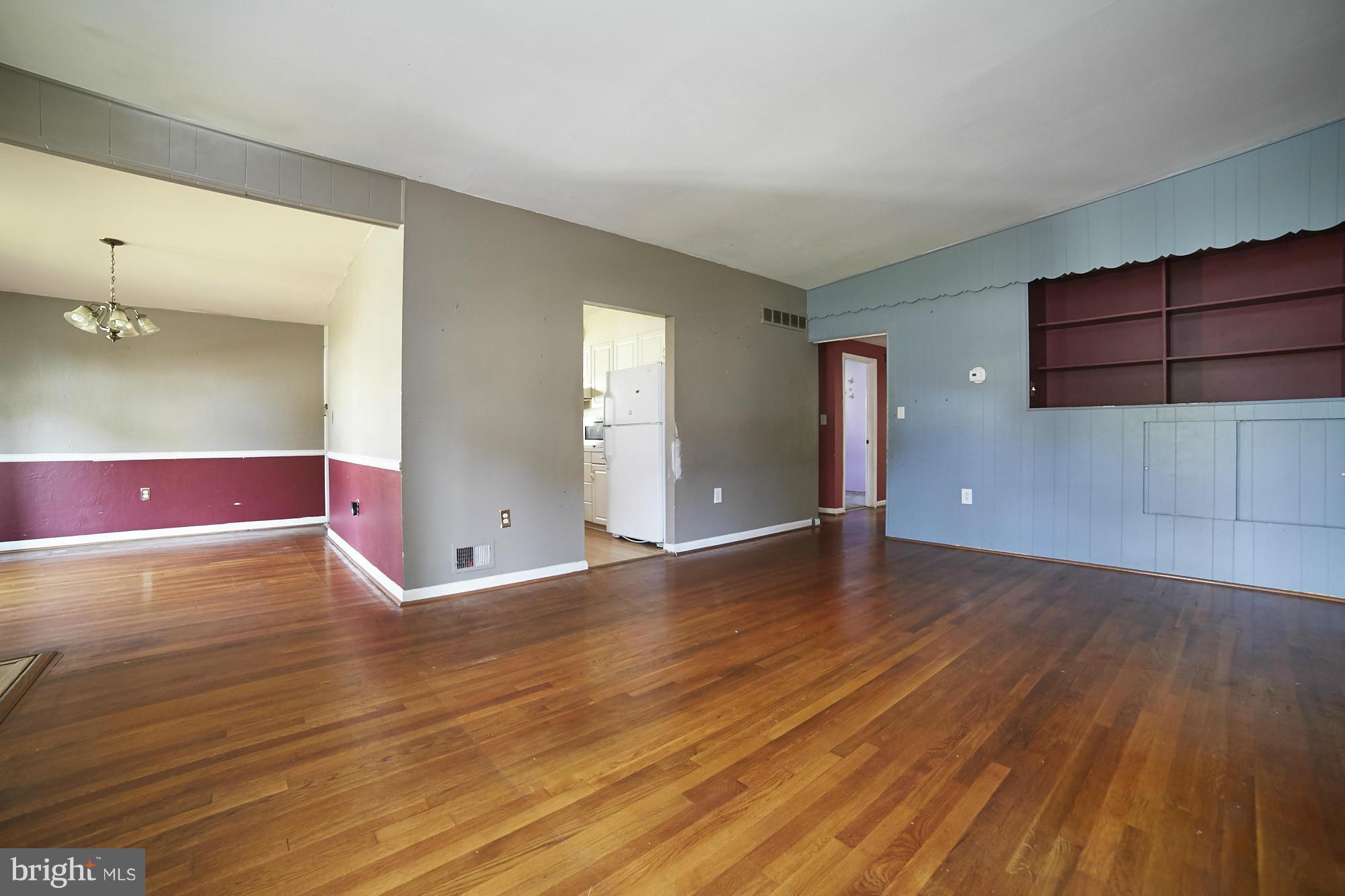 6851 Queens Ferry Road Baltimore, MD 21239 - Photo 6 of 25 a view of a room with wooden floor and cabinet