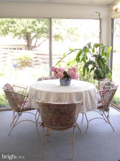 2715 Woodedge Road Silver Spring, MD 20906 - Photo 12 of 22 a dining room with furniture and a floor to ceiling window