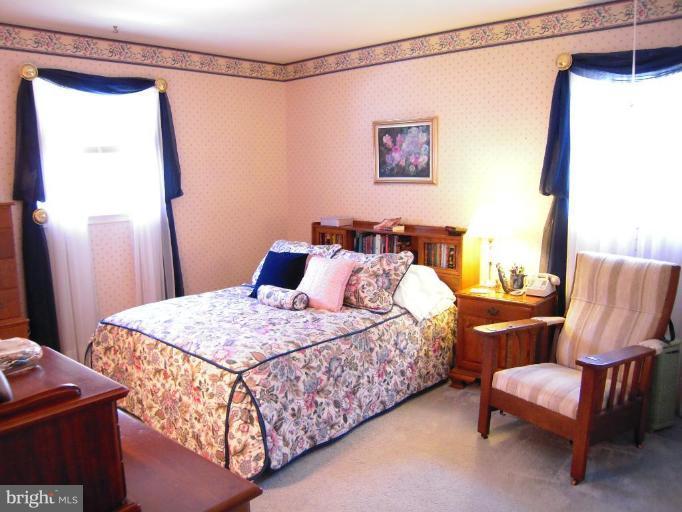 2715 Woodedge Road Silver Spring, MD 20906 - Photo 16 of 22 a bedroom with a bed and a couch