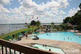 3238 Glenforest Road Montgomery, TX 77356 - Photo 39 of 41 Community swimming pool area, surrounded by lounge chairs and a scenic view of the lake. Ideal for relaxation and outdoor enjoyment.