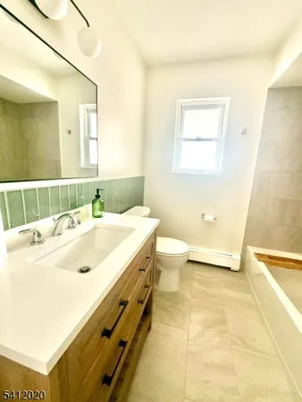a bath tub sitting next to a white sink