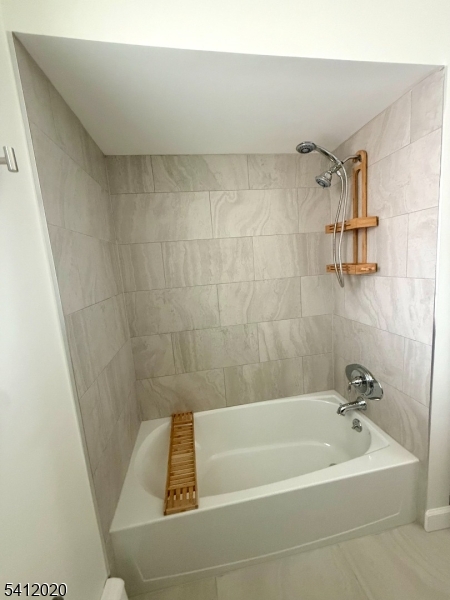 197 North Beverwyck Road, Unit 10 Lake Hiawatha, NJ 07034 - Photo 14 of 18 a bath tub sitting next to a white sink