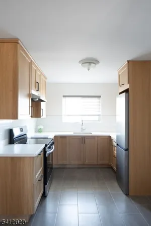 a kitchen with a sink and a refrigerator