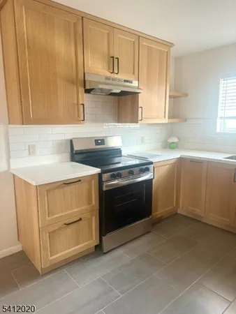 a kitchen with stainless steel appliances a stove sink and cabinets