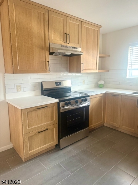 197 North Beverwyck Road, Unit 10 Lake Hiawatha, NJ 07034 - Photo 5 of 18 a kitchen with stainless steel appliances a stove sink and cabinets